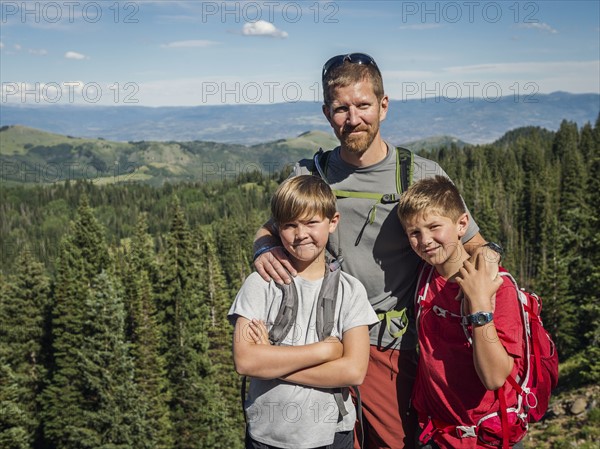 Father and sons (10-11, 12-13) outdoors