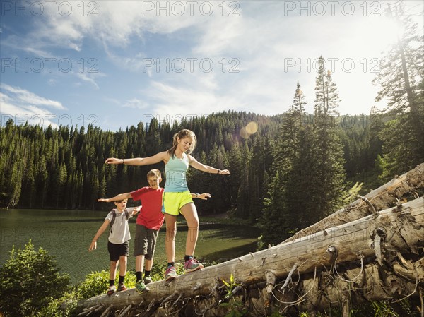 Children (10-11, 12-13, 14-15) walking on log