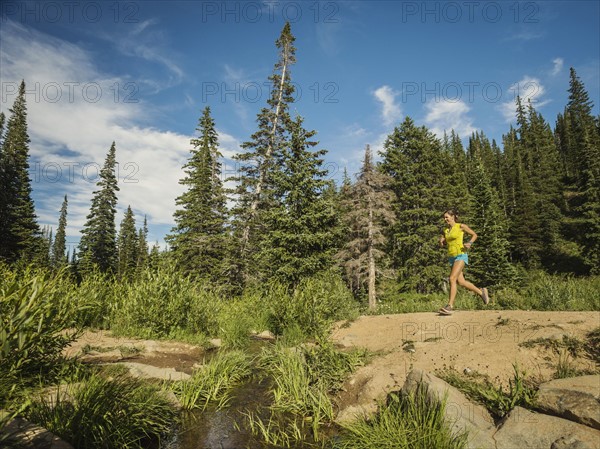 Mature woman running in forest