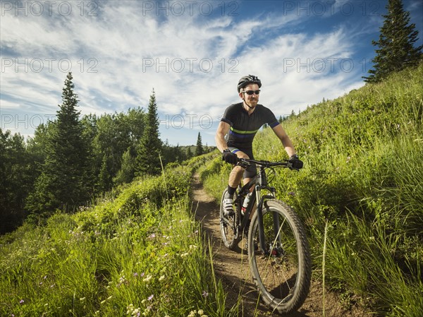 Mature man cycling outdoors