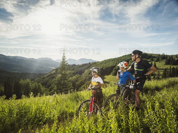 Father and sons (10-11, 12-13) looking at view