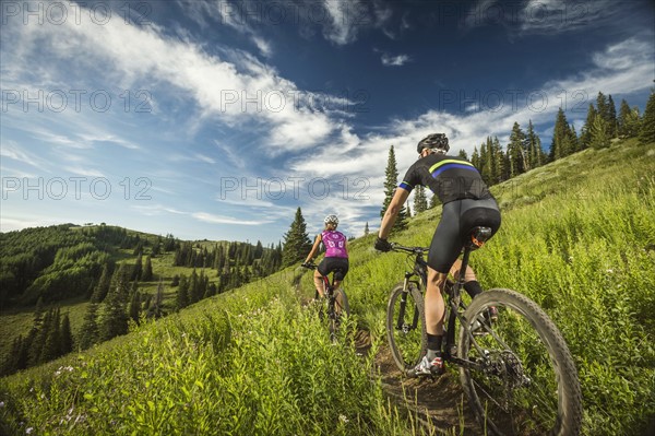 Mature couple during bicycle trip in mountain scenery