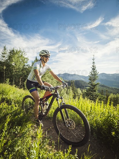Woman during bicycle trip in mountain scenery