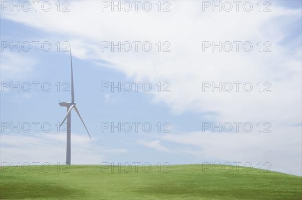 Wind turbine in field on sunny day