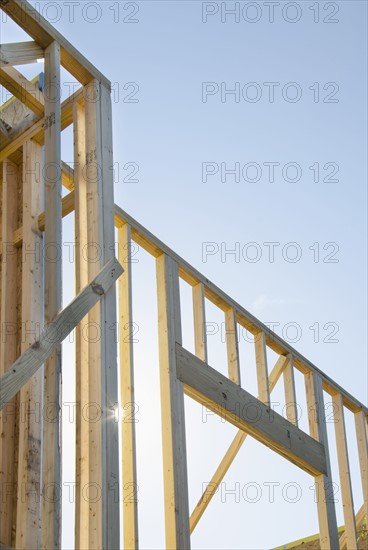 Wooden construction frames against clear sky
