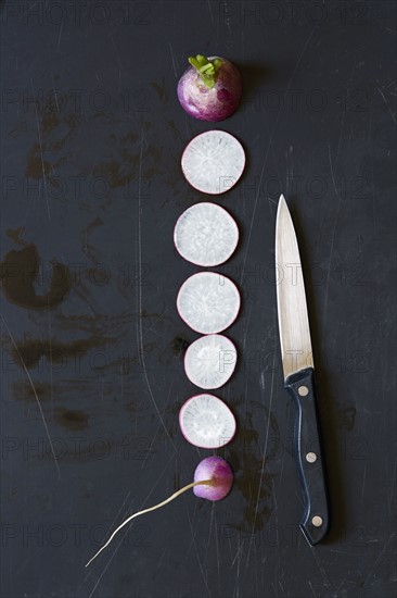 Slices of radish and kitchen knife