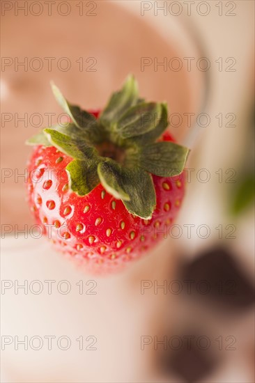 Close-up of strawberry, chocolate smoothie in background