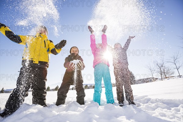 Children (8-9, 10-11) playing with snow