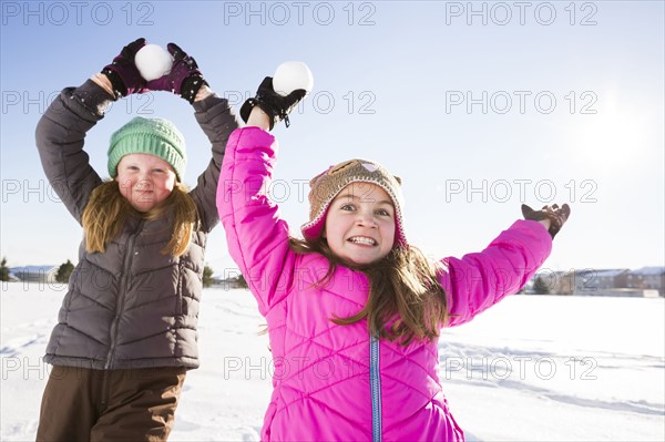 Girls (8-9, 10-11) playing with snowballs