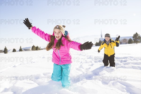 Children (8-9, 10-11) playing in snow