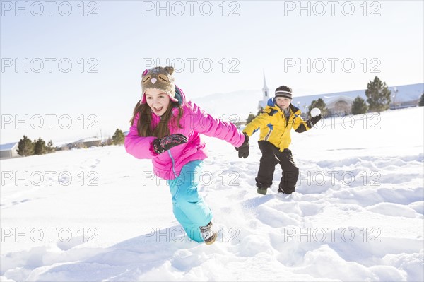Children (8-9, 10-11) playing in snow
