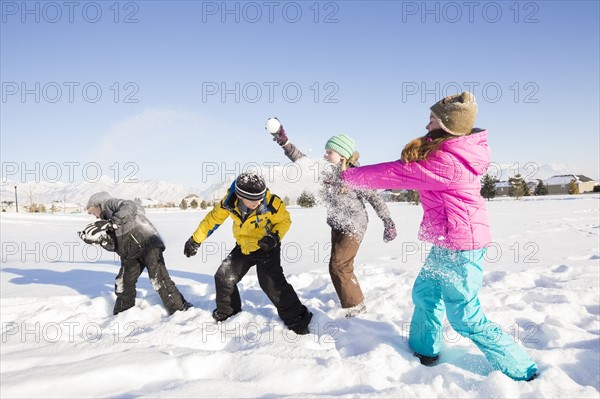 Children (8-9, 10-11) playing in snow