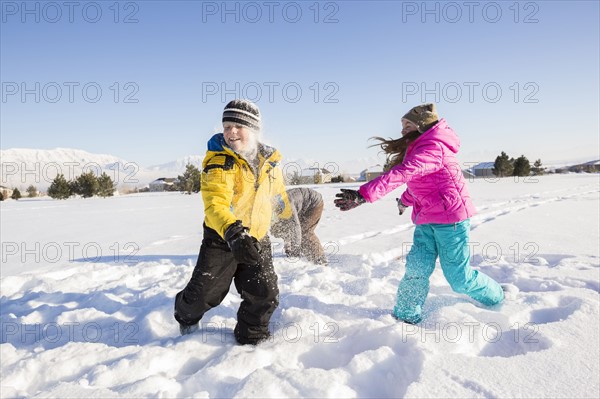 Children (8-9, 10-11) playing in snow