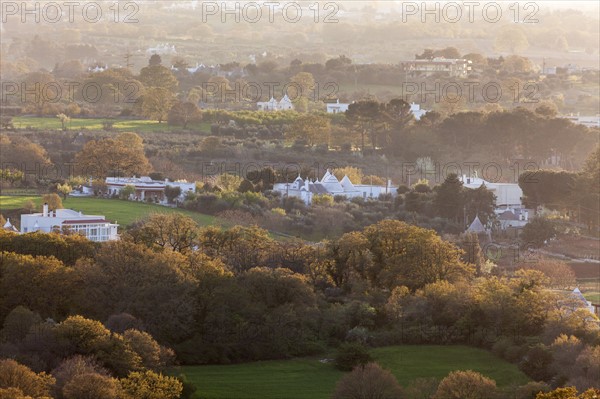 Landscape with trulli houses at sunset