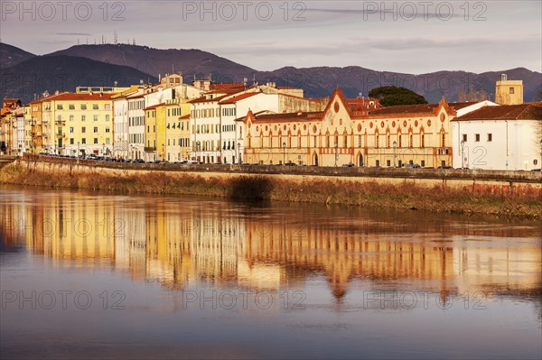 Townhouses by Arno river at sunset