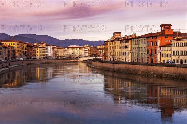 Townhouses by Arno river at sunset