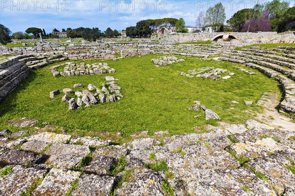 Rocks of Paestum ruins in circle on grass