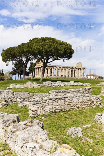 Old ruins on grass under cloudy sky