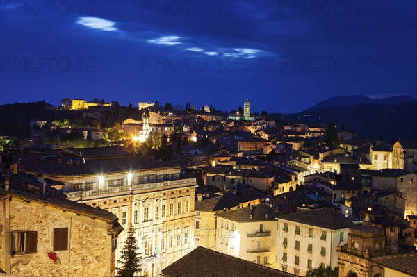 Illuminated townscape under cloudy sky