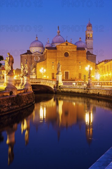 Illuminated buildings of Prato della Valle with statues at dusk, Padua