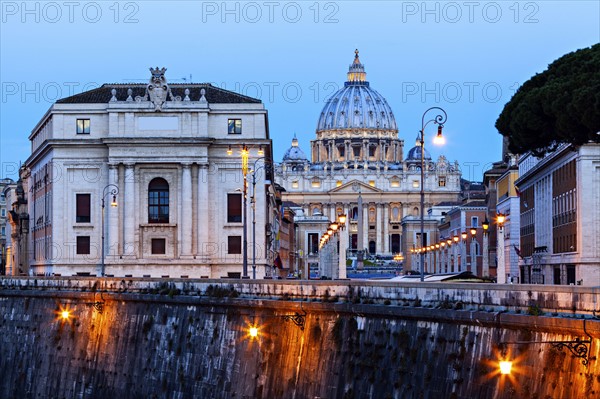 Illuminated St. Peter's Basilica at dusk