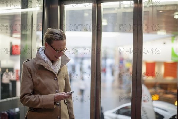 Woman using phone in store