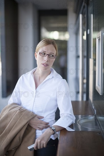 Businesswoman standing by ticket counter