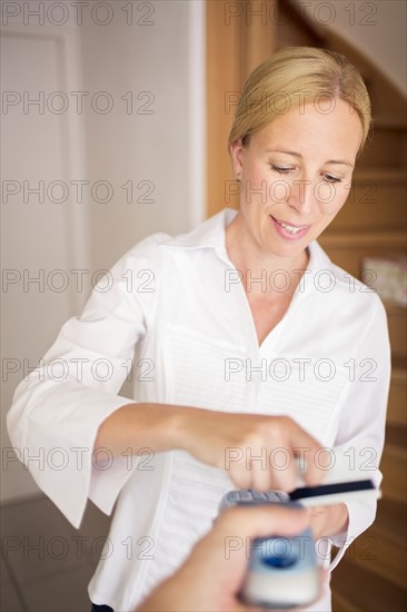 Woman paying by credit card