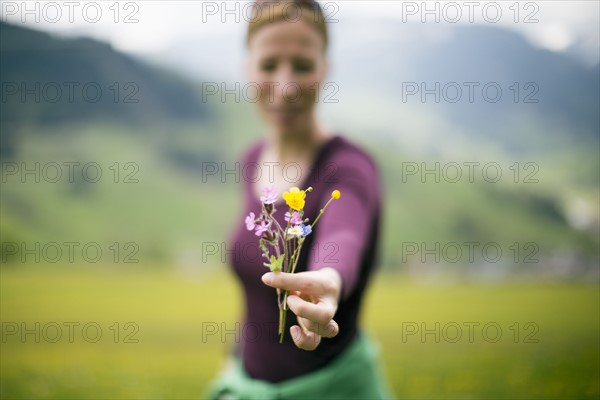 Woman holding wild flowers