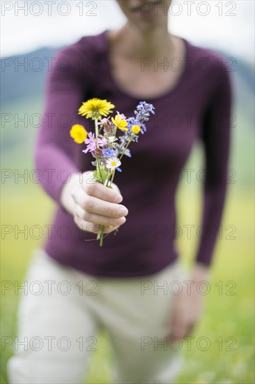 Woman holding wild flowers