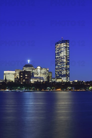 Illuminated waterfront buildings at dusk