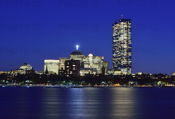 Illuminated waterfront buildings at dusk