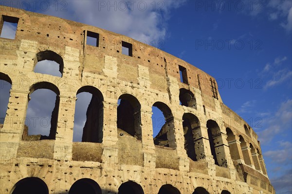 Facade of Coliseum against cloudy sky