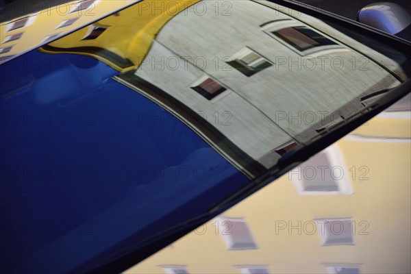 Reflection of building in car windshield