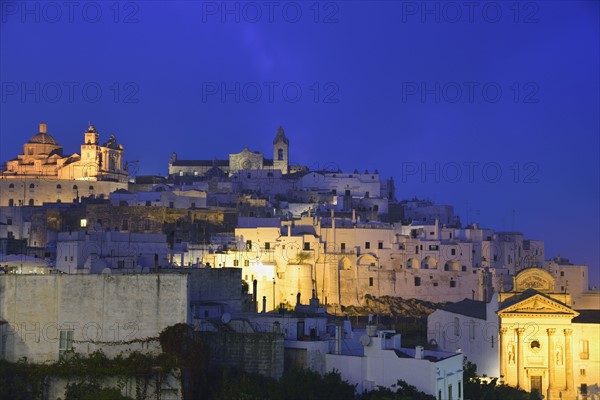 Old town against sky at dusk