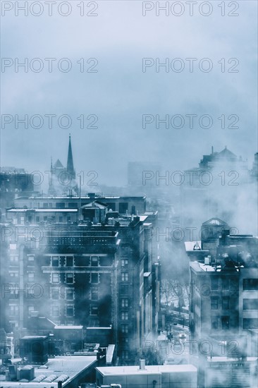 Steam above buildings in winter