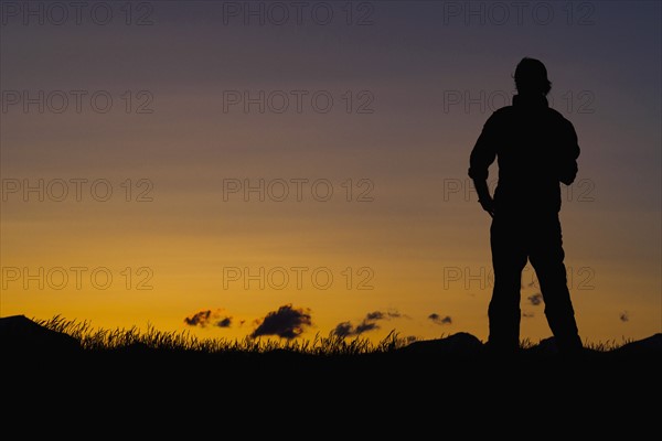 Silhouette of man standing at dusk