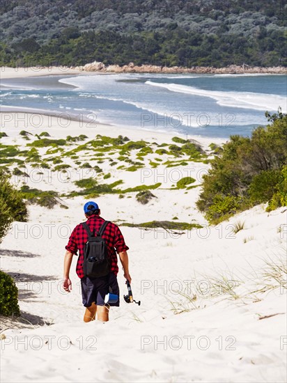 Mid adult man walking on beach