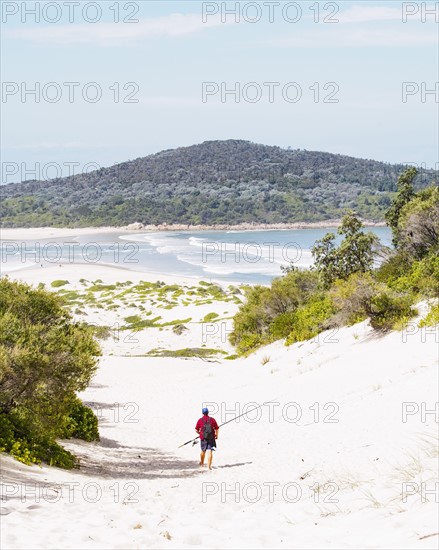 Mid adult man walking on beach