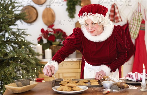 Mrs. Claus making gingerbread cookies.