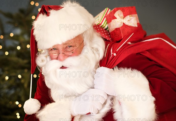 Portrait of Santa Claus carrying sack over shoulder.