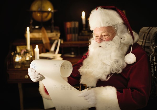 Portrait of Santa Claus reading child's letter.