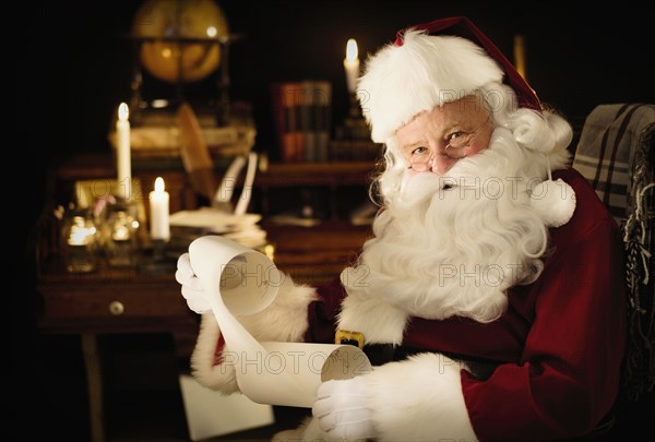 Portrait of Santa Claus reading child's letter.