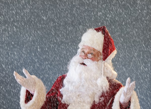 Portrait of Santa Claus looking up and gesturing.