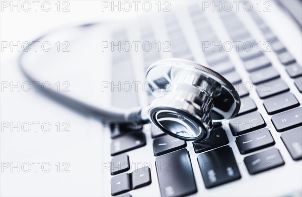 Stethoscope lying on computer keyboard.