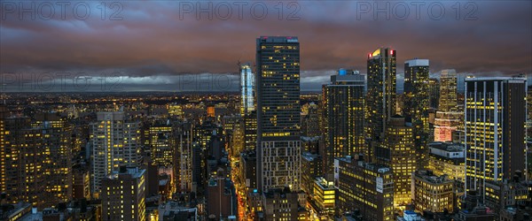 Illuminated cityscape at night. USA, New York, New York City.