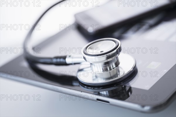 Stethoscope lying on digital tablet.