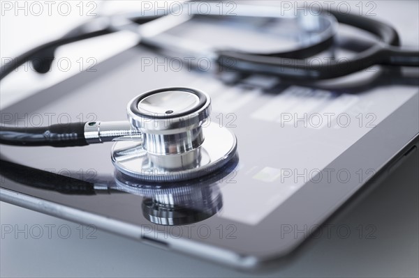 Stethoscope lying on digital tablet.