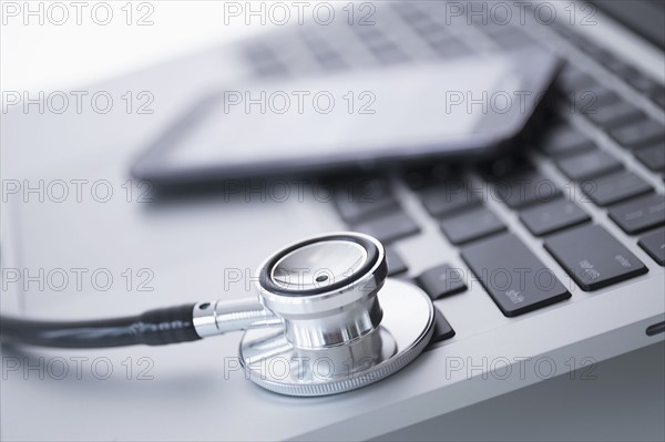 Stethoscope lying on laptop.