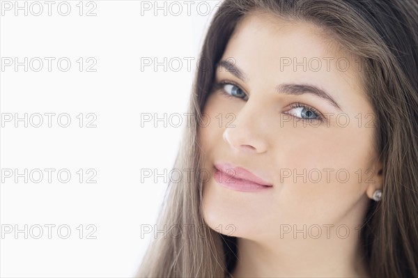 Portrait of young woman with brown hair.